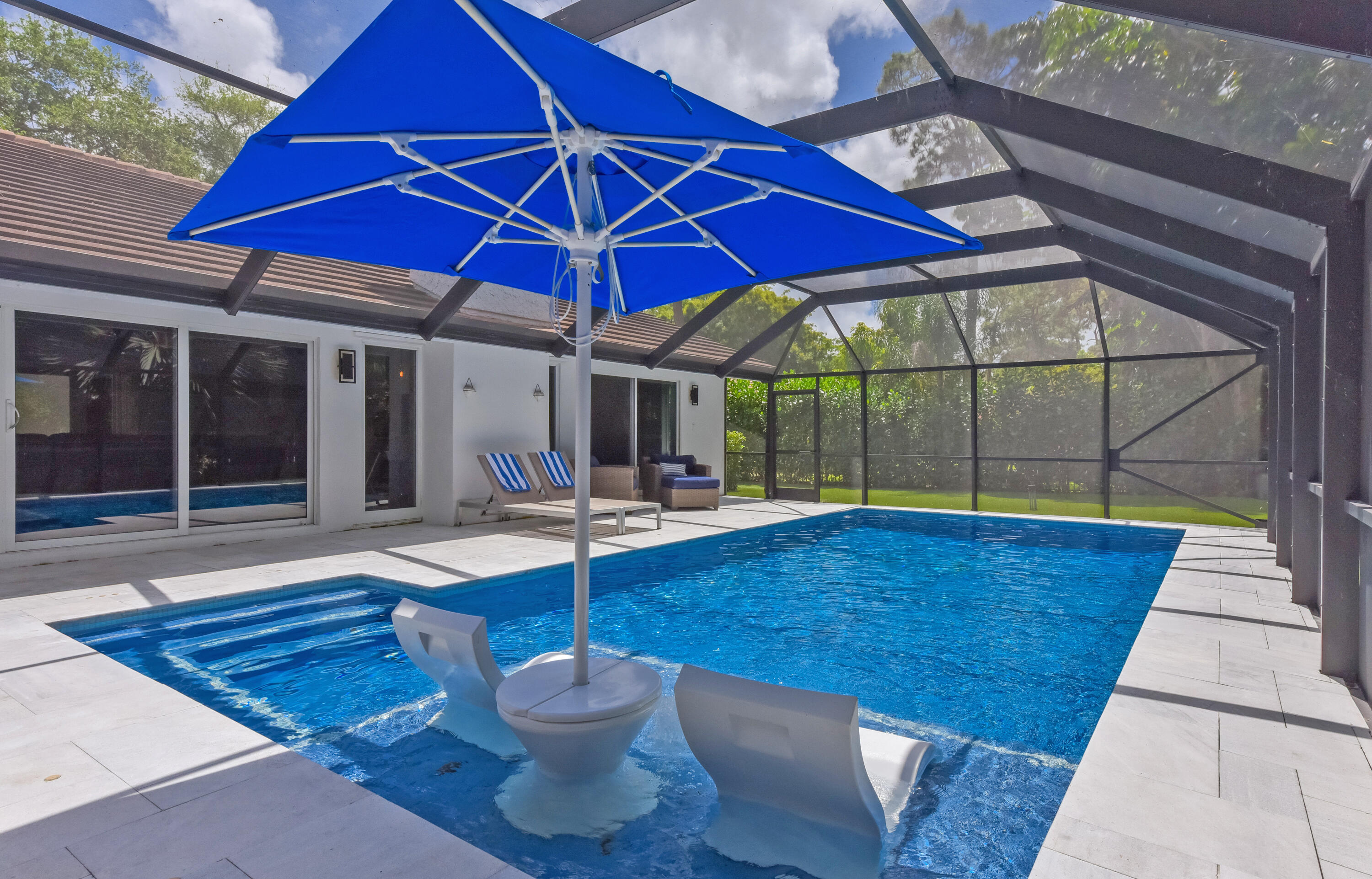 2659 Northwest 26th Circle Boca Raton, FL 33431 - Photo 27 of 34 a view of a patio with table and chairs under an umbrella