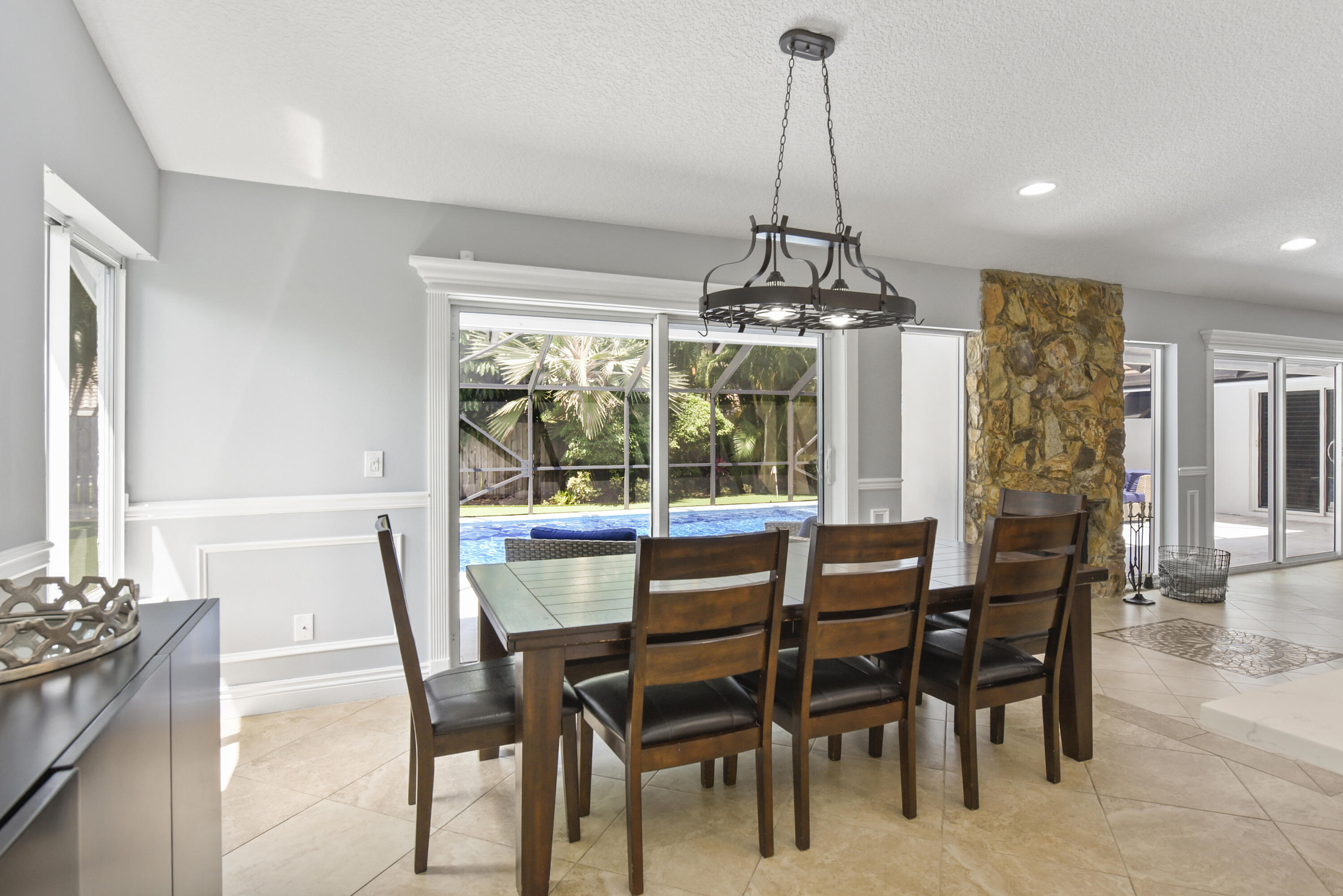 2659 Northwest 26th Circle Boca Raton, FL 33431 - Photo 9 of 34 a dining room with furniture a chandelier and wooden floor