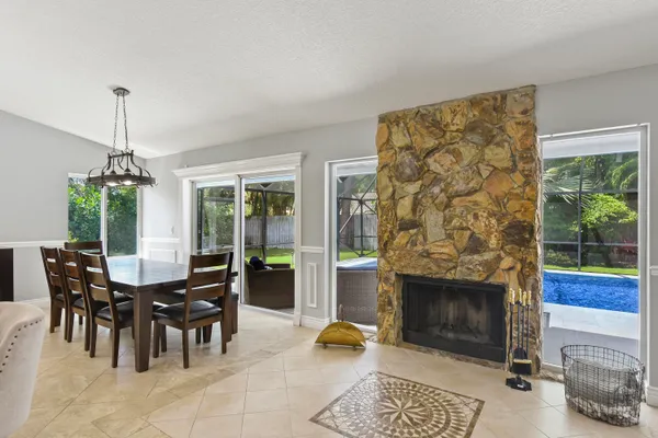 a view of a livingroom with furniture and floor to ceiling window