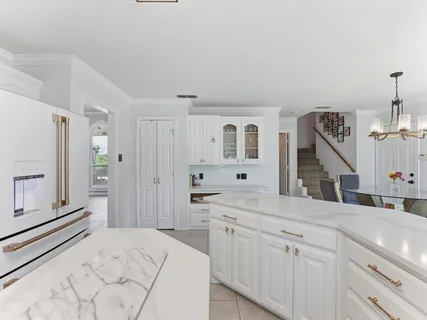 a spacious bathroom with a sink and a mirror