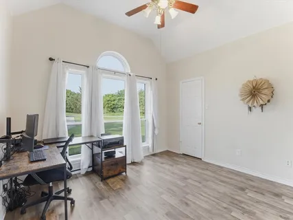 a living room with furniture a window and a chandelier