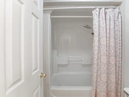 a close up of a bathtub curtain