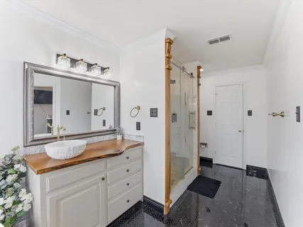 a spacious bathroom with a granite countertop sink mirror and shower