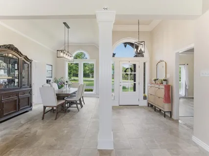 a view of a livingroom with furniture window and a chandelier
