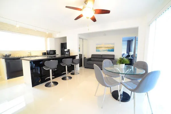 a dining room with furniture and window