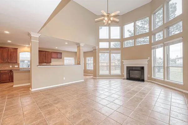 a view of an empty room with a fireplace and a window