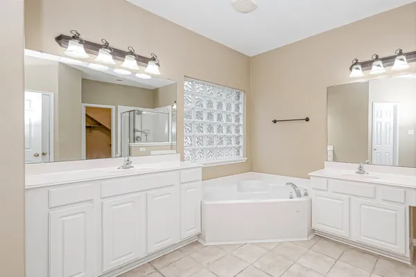 a bathroom with a sink a light fixture and a mirror