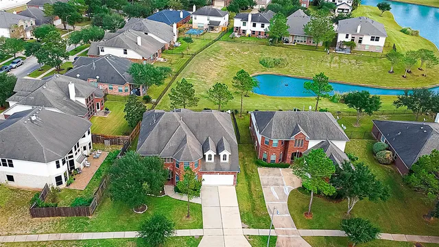 an aerial view of residential houses with outdoor space and street view