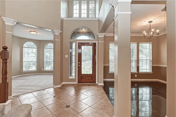 a view of a entryway door with hallway and a livingroom