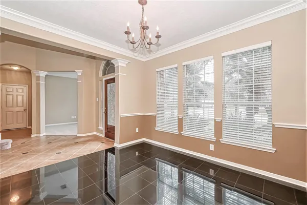 a spacious bathroom with a granite countertop sink a large mirror and a bathtub with shower