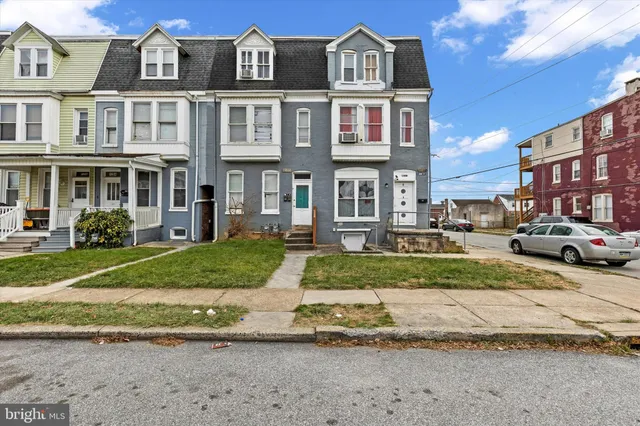 a front view of a residential apartment building with a yard