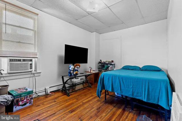 a bedroom with furniture and a flat screen tv