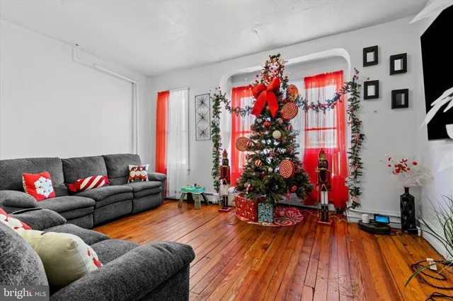 a living room with furniture and wooden floor