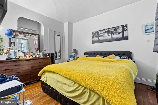 a bed sitting in a bedroom and table