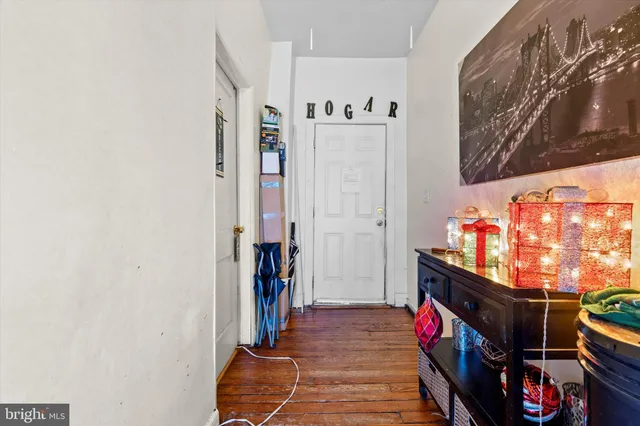 a view of a hallway with wooden floor and entryway
