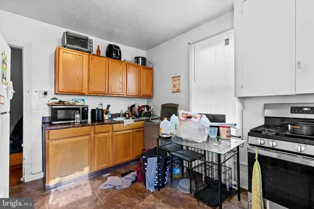 a kitchen with stainless steel appliances granite countertop a stove top oven a sink dishwasher and cabinets with wooden floor