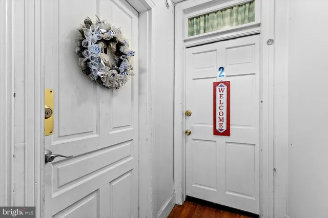 a view of an entryway with wooden floor