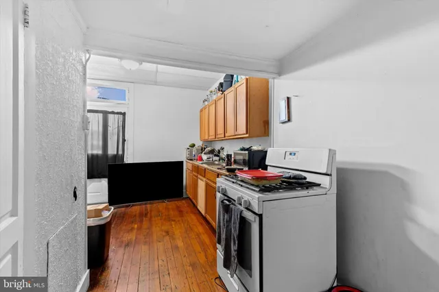a kitchen with stainless steel appliances a stove and a microwave