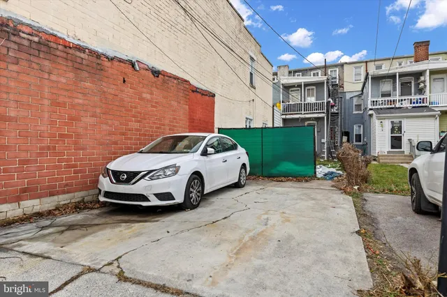 a car parked in front of a brick building