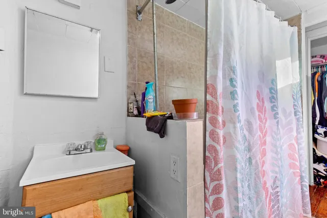 a bathroom with a sink vanity and mirror