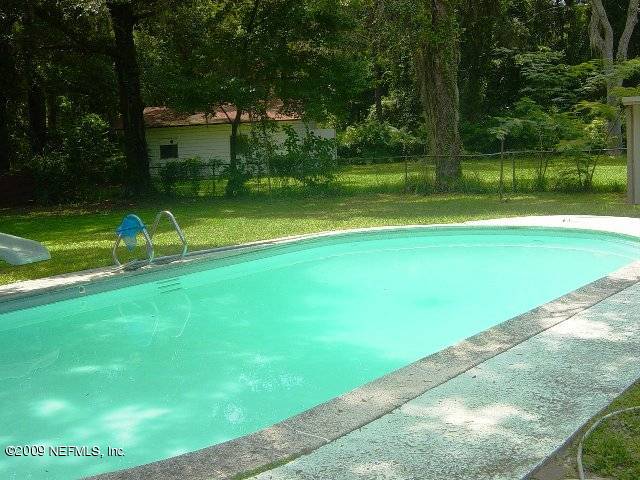 8820 Sanchez Road Jacksonville, FL 32217 - Photo 3 of 12 a view of yard with swimming pool and green space