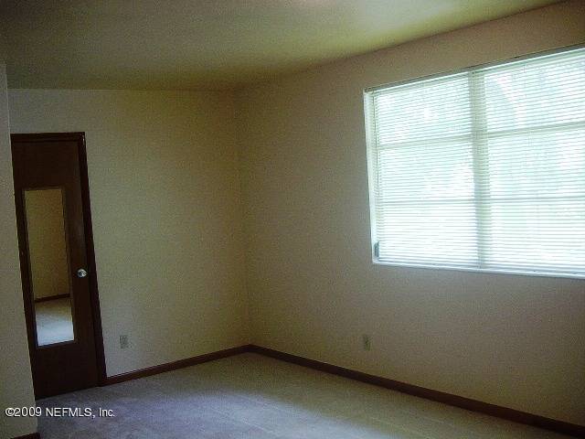 8820 Sanchez Road Jacksonville, FL 32217 - Photo 8 of 12 an empty room with a window