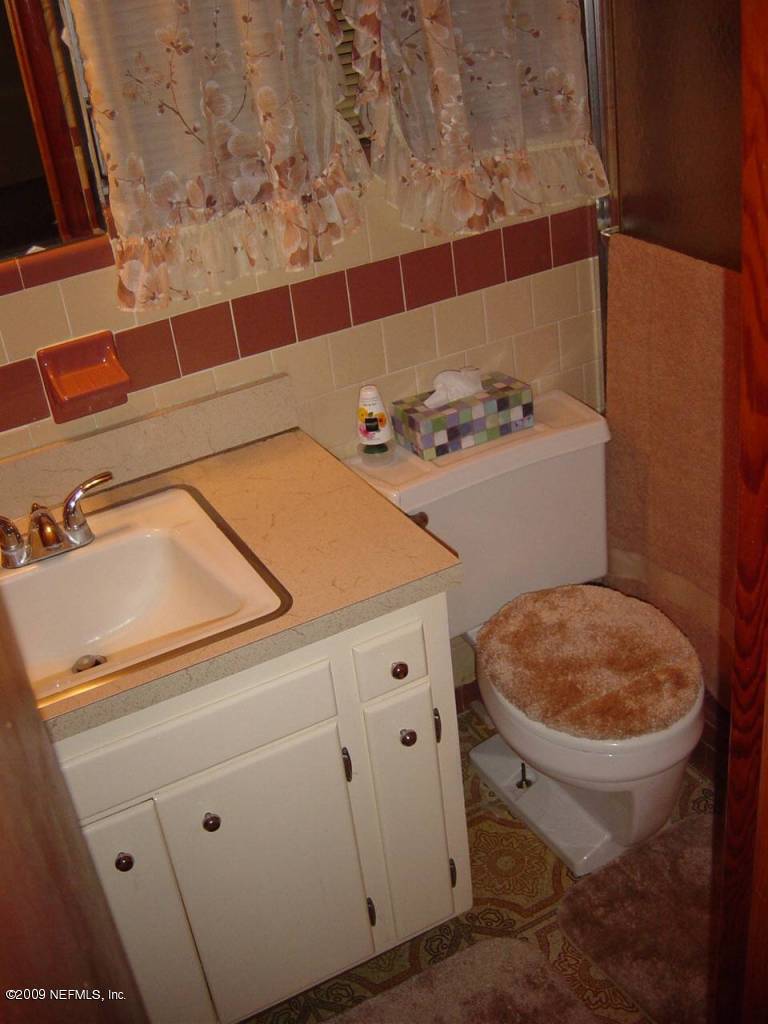 8820 Sanchez Road Jacksonville, FL 32217 - Photo 9 of 12 a bathroom with a sink and a toilet