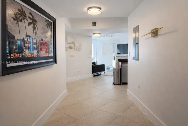 a kitchen with a refrigerator and cabinets