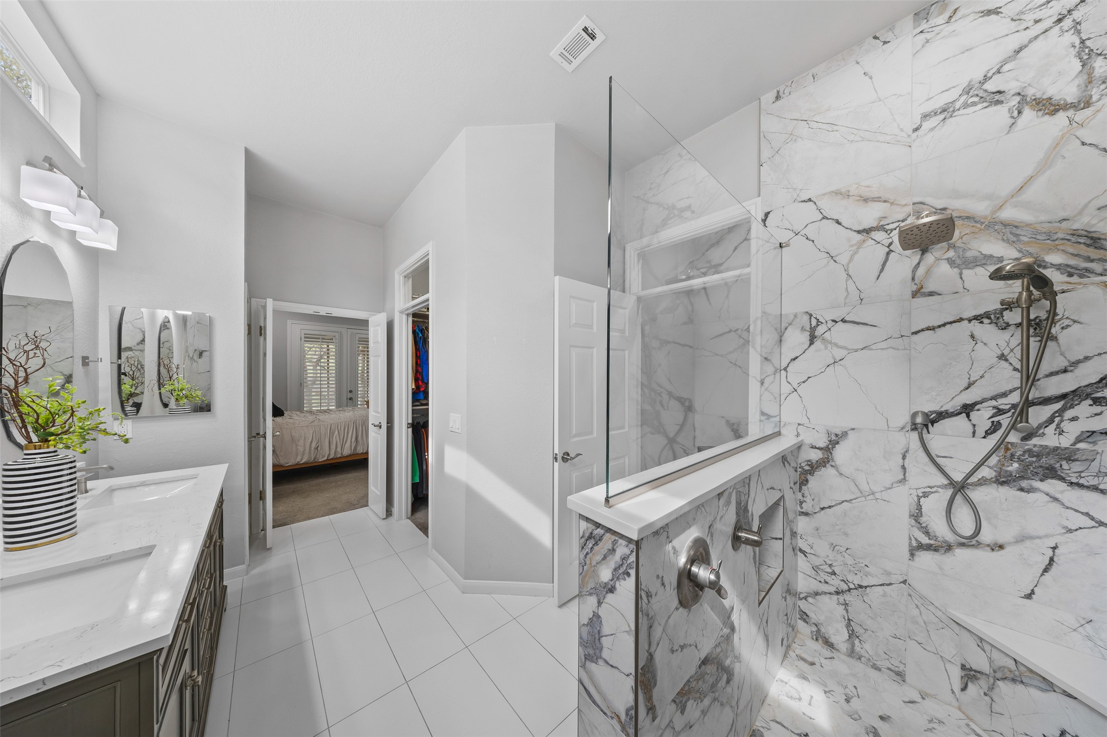 144 Stetson Trail Georgetown, TX 78633 - Photo 28 of 39 Ensuite bathroom with a marble finish shower, double vanity, and light tile patterned floors