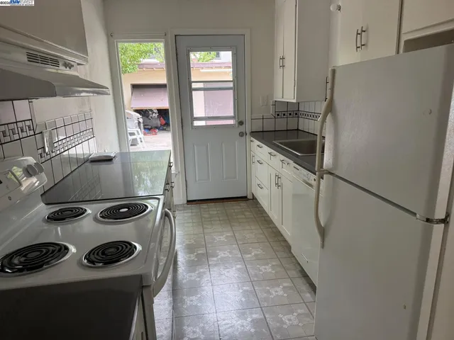 a kitchen with a stove and a refrigerator