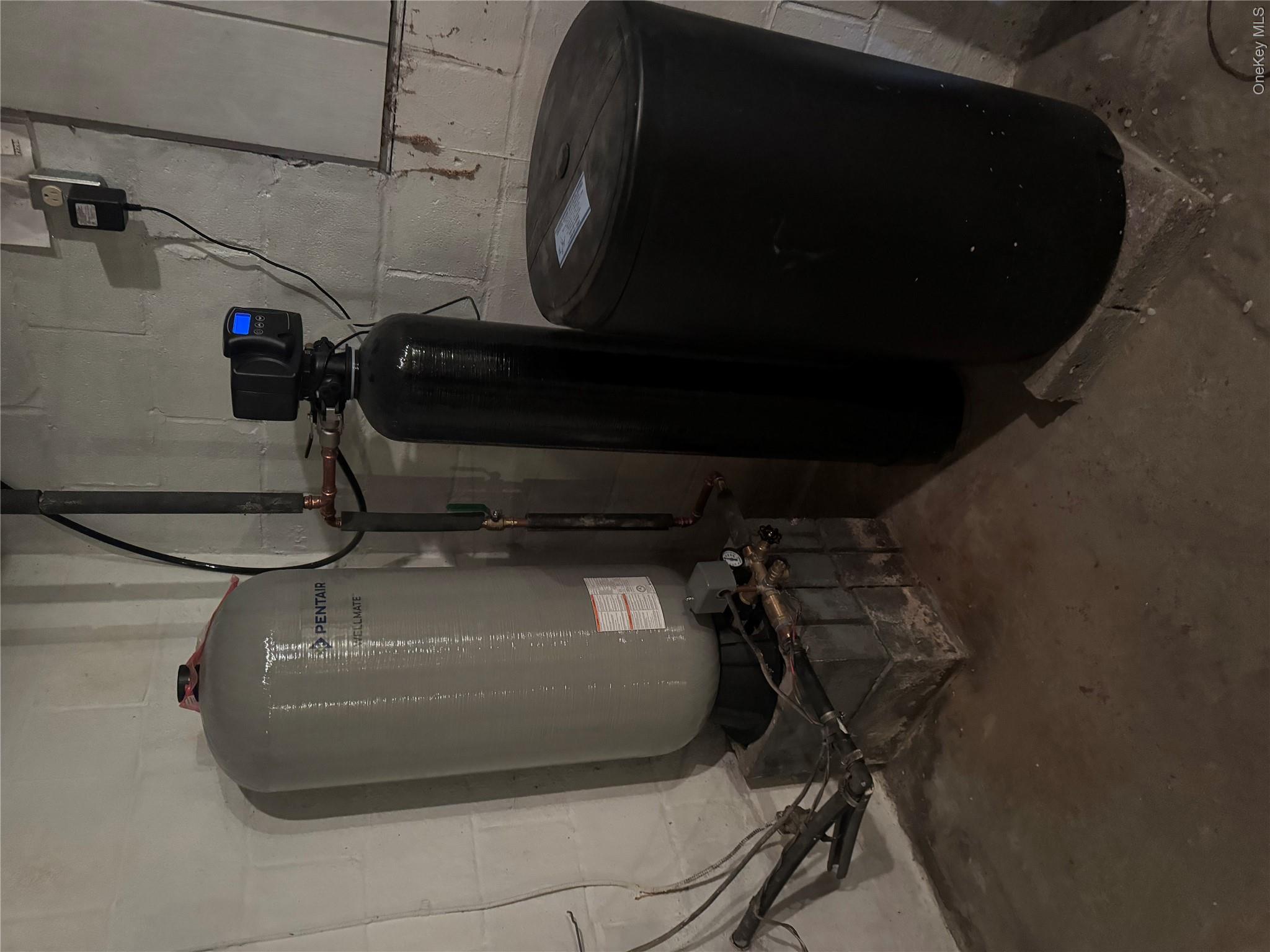 367 Mt Eve Road Goshen, NY 10924 - Photo 31 of 37 a room with water heater and wooden cabinets