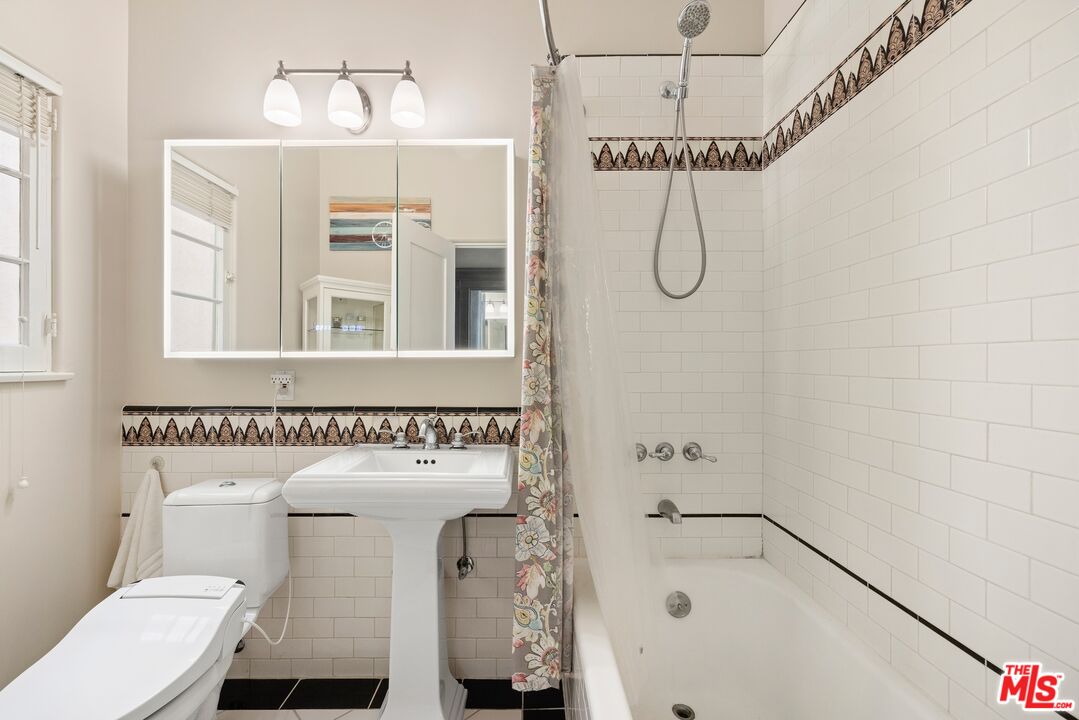 827 12th Street Santa Monica, CA 90403 - Photo 11 of 15 a bathroom with a shower a toilet and a sink