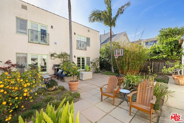 a view of a patio with table and chairs potted plants