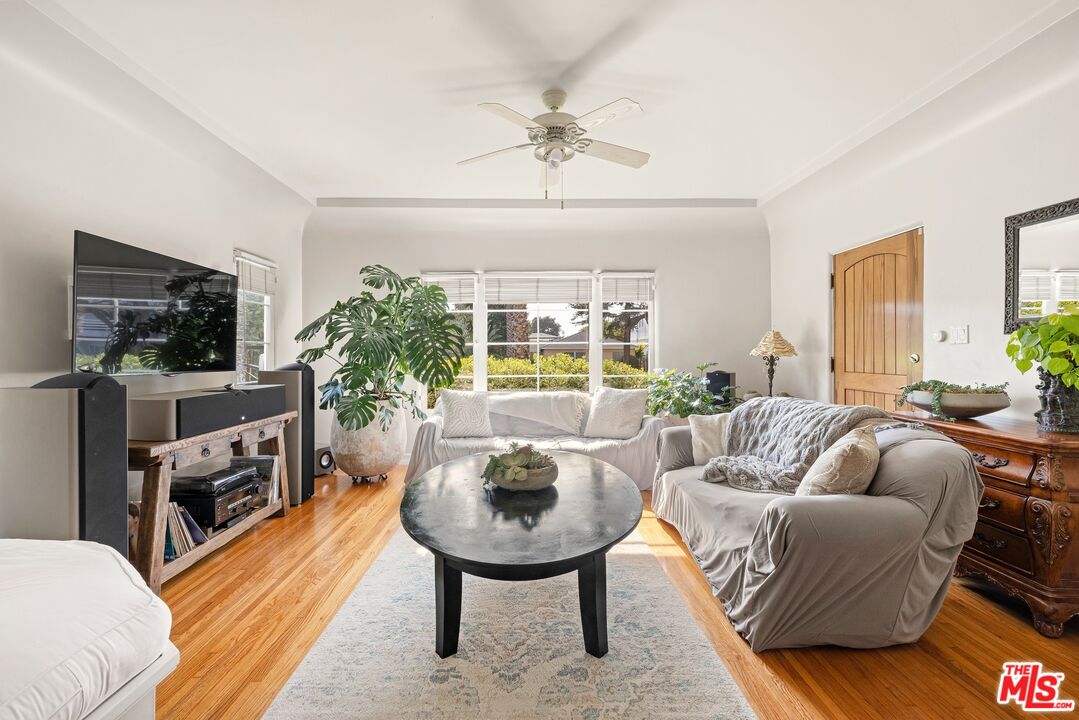 827 12th Street Santa Monica, CA 90403 - Photo 8 of 15 a living room with furniture a fireplace and a flat screen tv