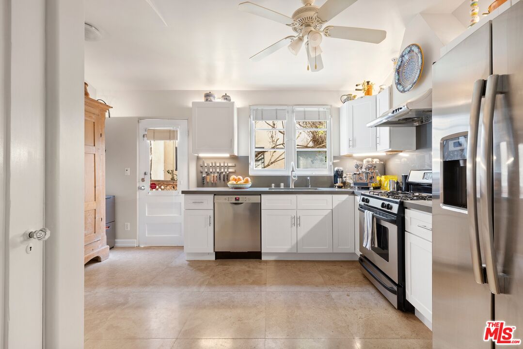 827 12th Street Santa Monica, CA 90403 - Photo 10 of 15 a kitchen with stainless steel appliances a refrigerator sink and cabinets