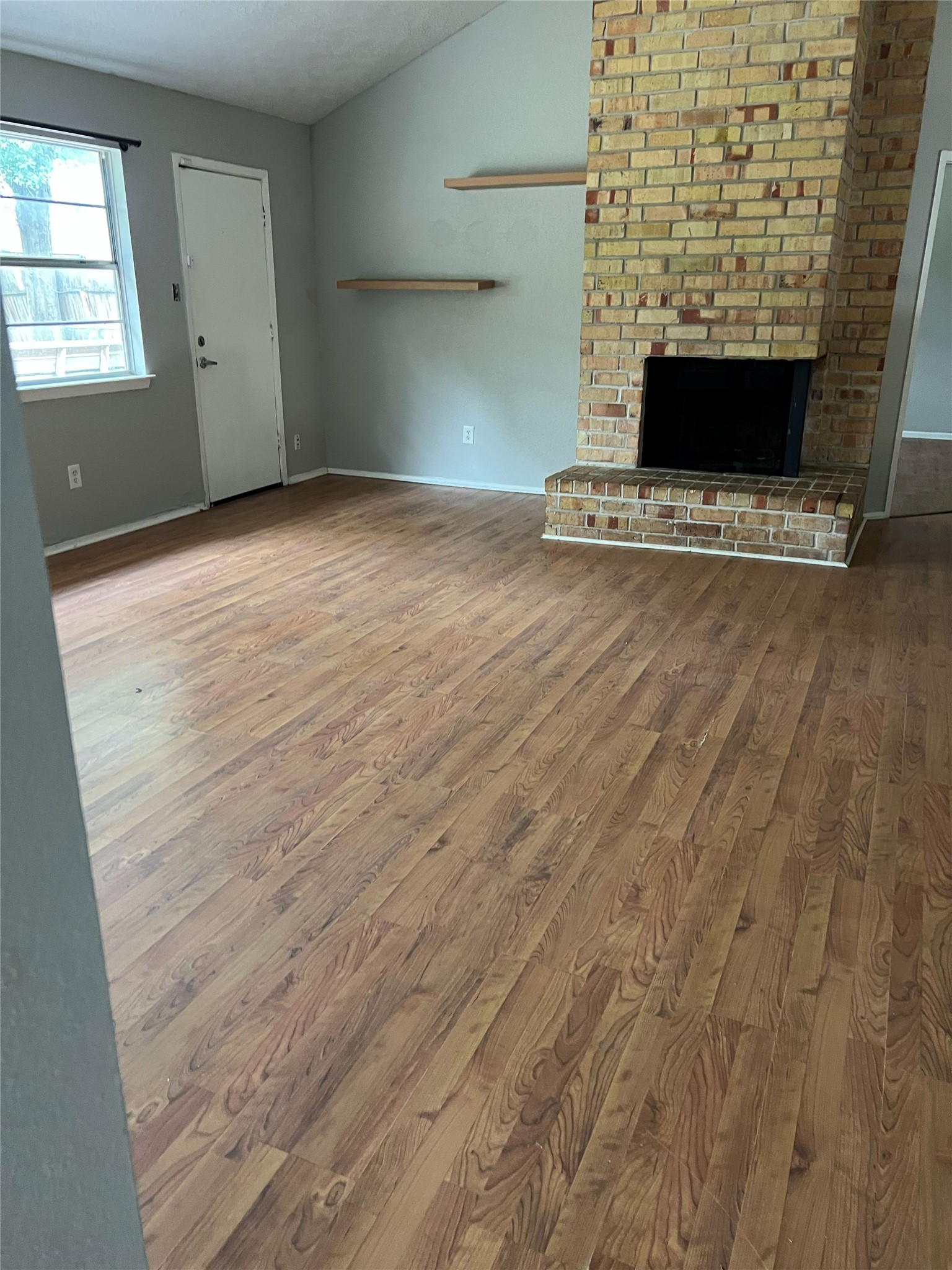 6507 Bridgegate Drive Spring, TX 77373 - Photo 3 of 17 an empty room with wooden floor and a fireplace