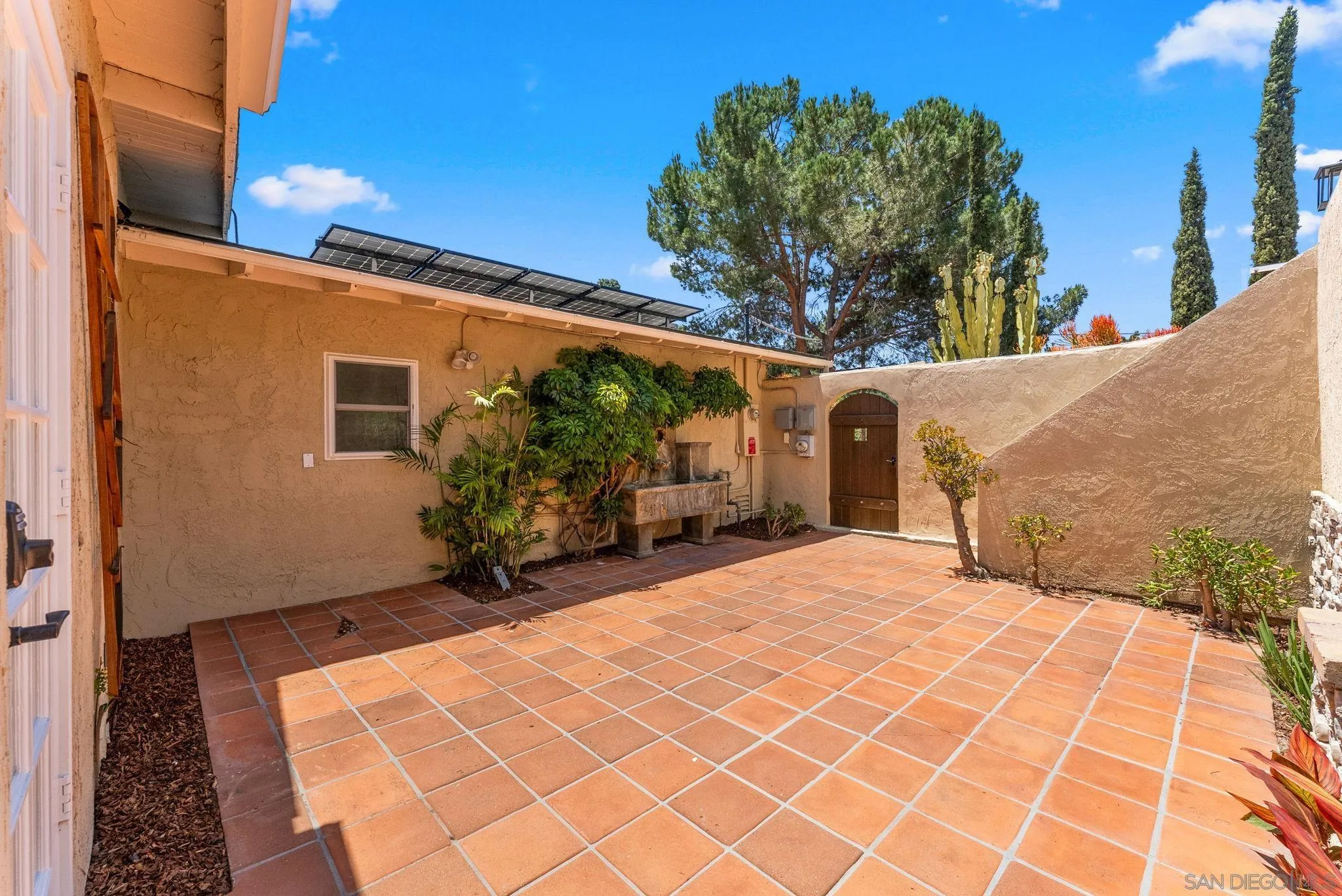 12832 Stone Canyon Road Poway, CA 92064 - Photo 34 of 60 a backyard of a house with potted plants and trees