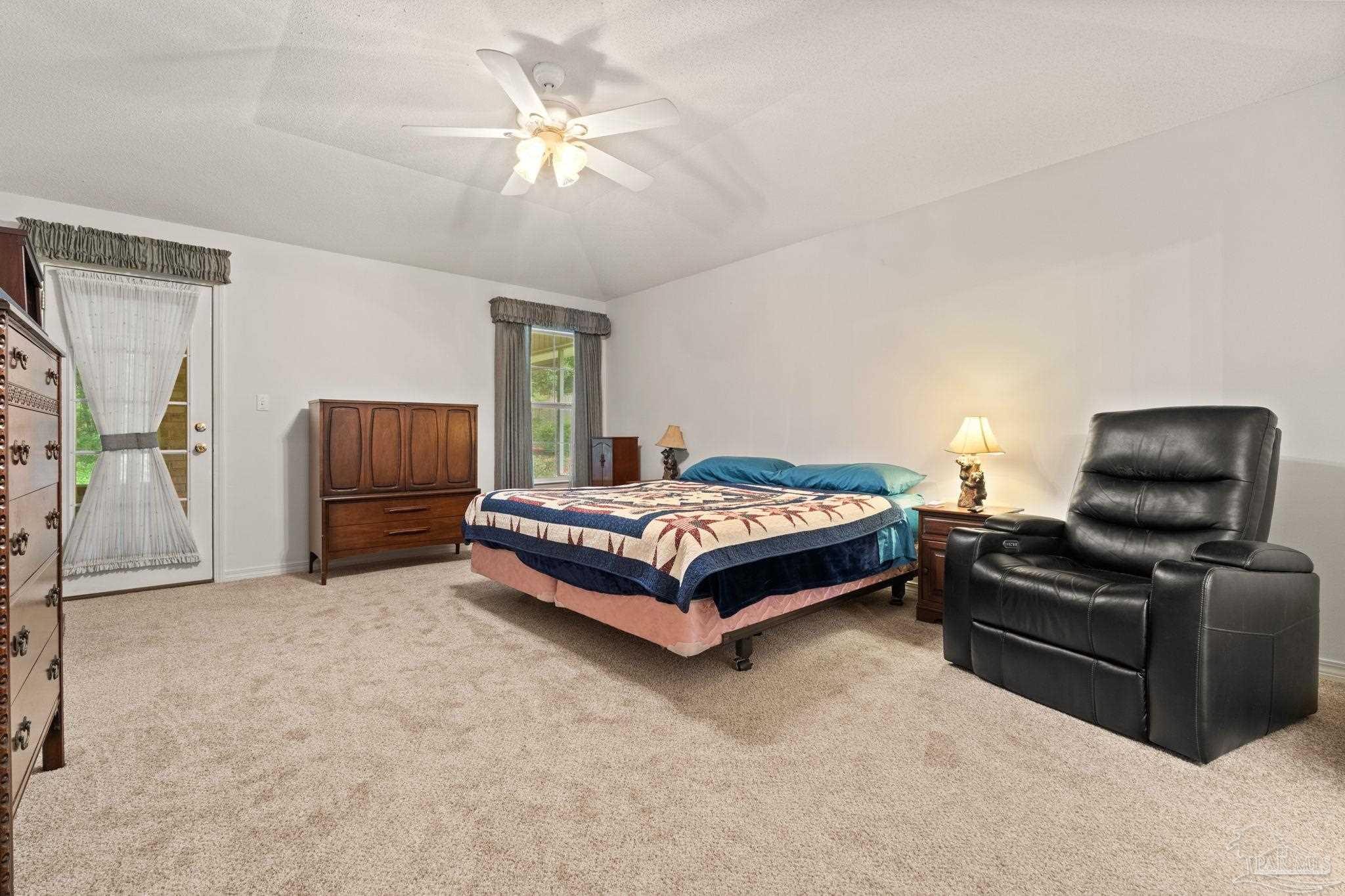5073 Brookside Drive Pace, FL 32571 - Photo 23 of 38 a bedroom with a bed and a chair