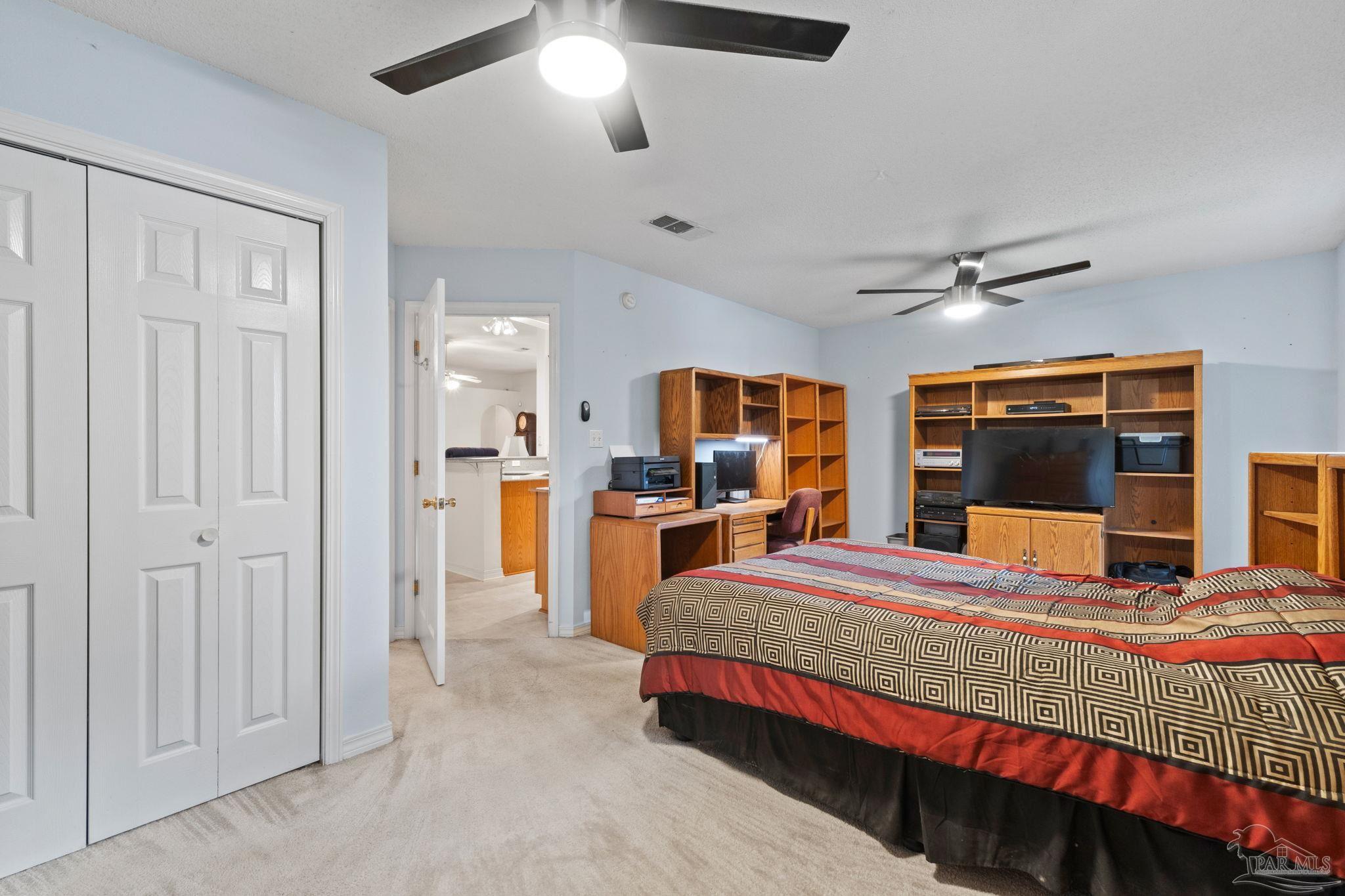 5073 Brookside Drive Pace, FL 32571 - Photo 29 of 38 a bedroom with a bed and a walk in closet