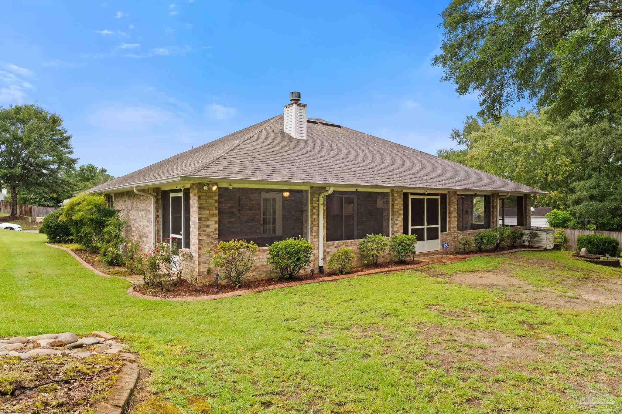 5073 Brookside Drive Pace, FL 32571 - Photo 34 of 38 a front view of house with yard patio and green space