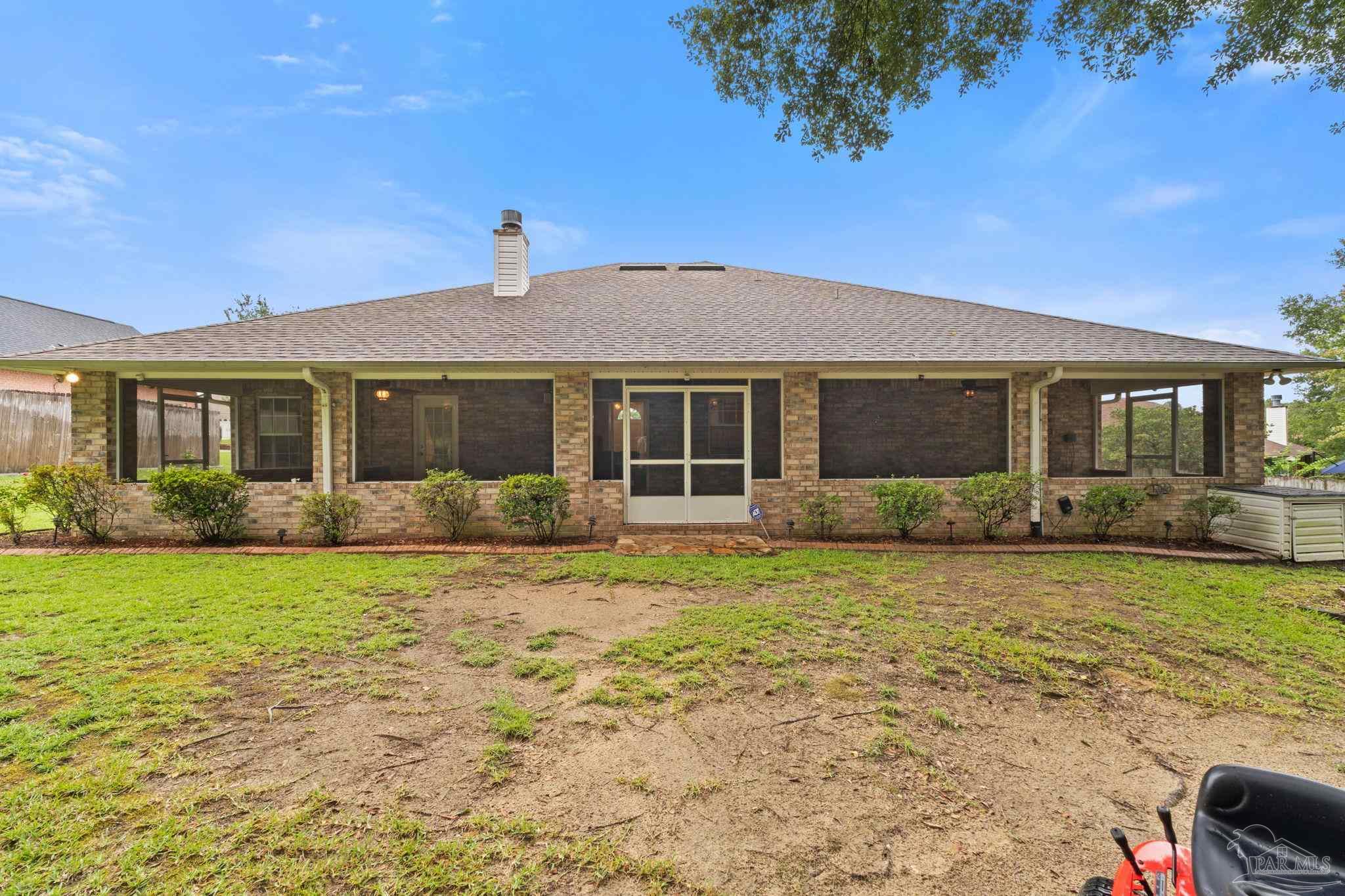 5073 Brookside Drive Pace, FL 32571 - Photo 35 of 38 a front view of a house with garden