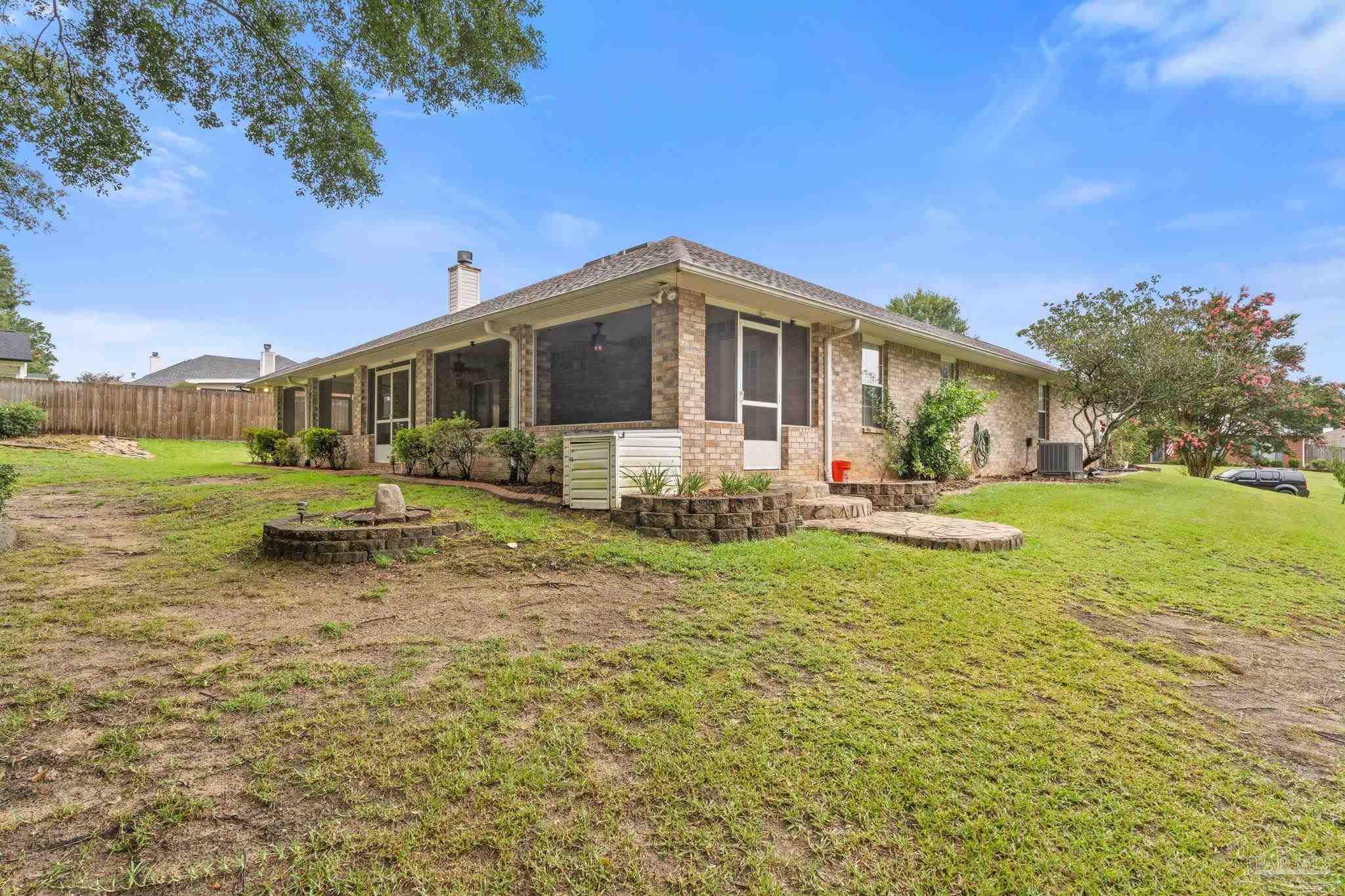 5073 Brookside Drive Pace, FL 32571 - Photo 36 of 38 a front view of a house with garden