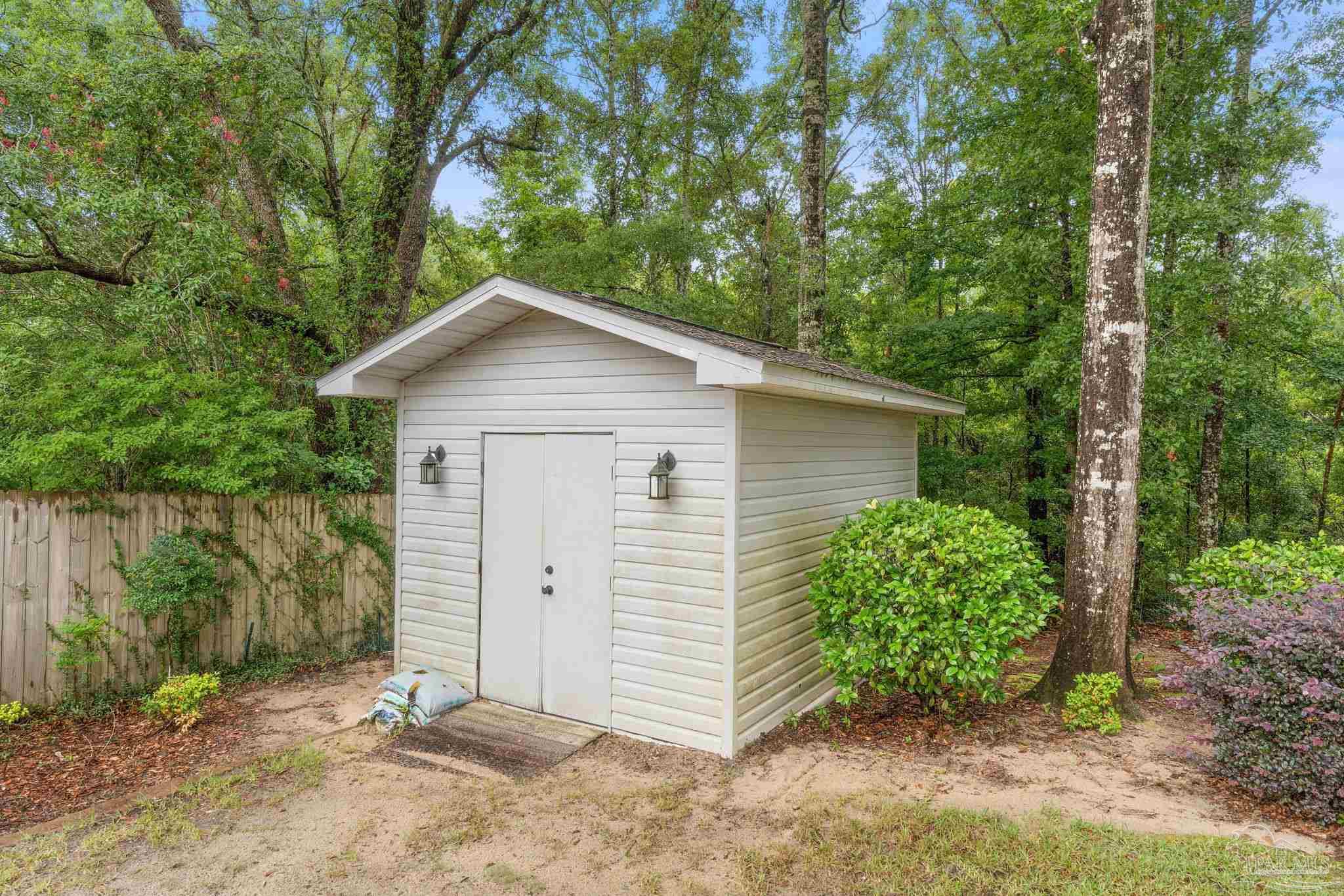 5073 Brookside Drive Pace, FL 32571 - Photo 38 of 38 a view of a house with a yard and large tree