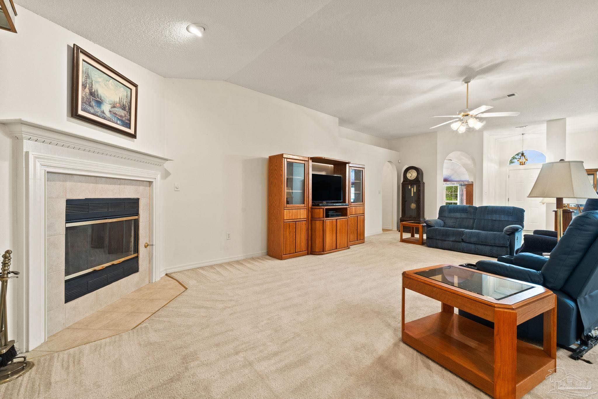 5073 Brookside Drive Pace, FL 32571 - Photo 9 of 38 a living room with furniture and a fireplace