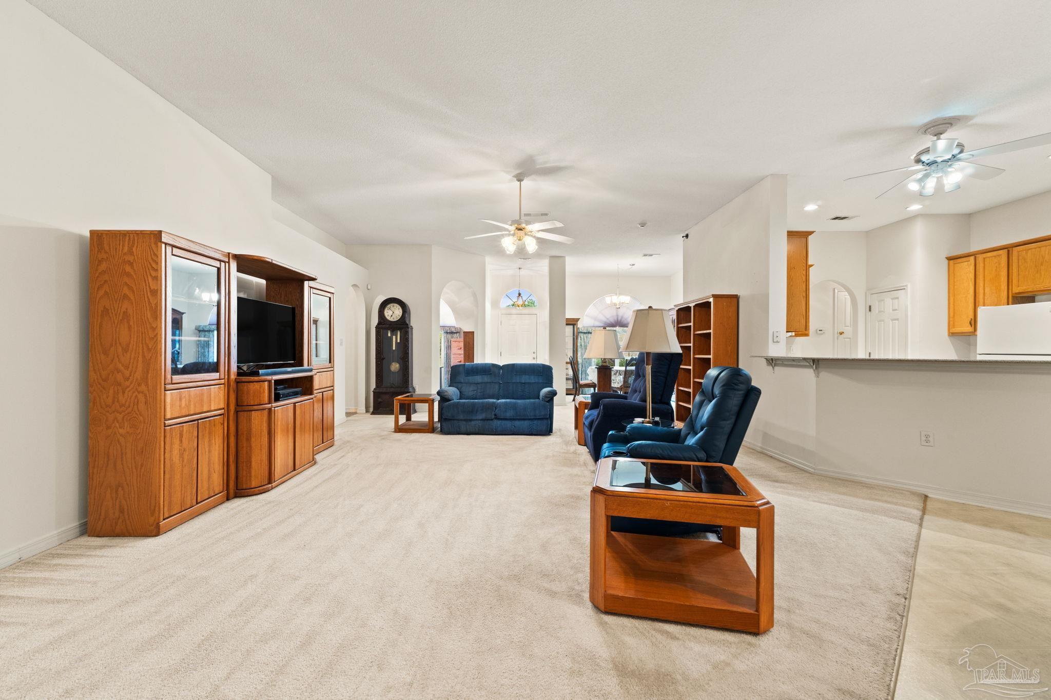 5073 Brookside Drive Pace, FL 32571 - Photo 10 of 38 a living room with furniture and flat screen tv