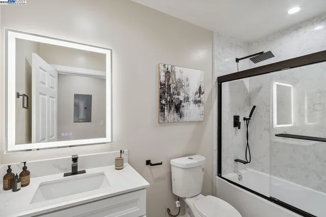 a bathroom with a sink toilet and shower