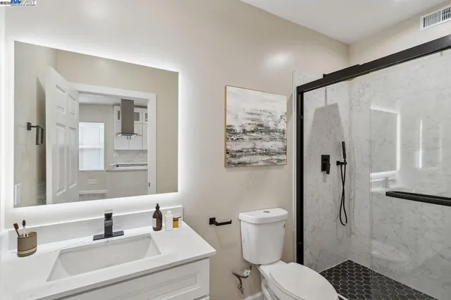 a bathroom with a sink toilet and shower