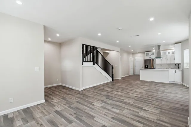 a view of empty room with wooden floor
