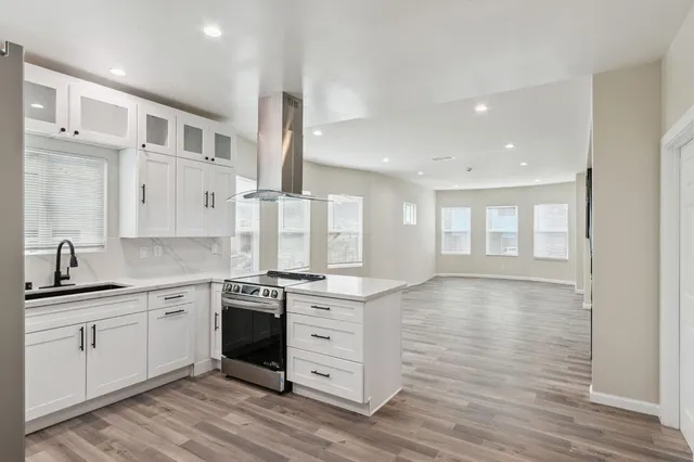 a kitchen with stainless steel appliances granite countertop a stove and a sink