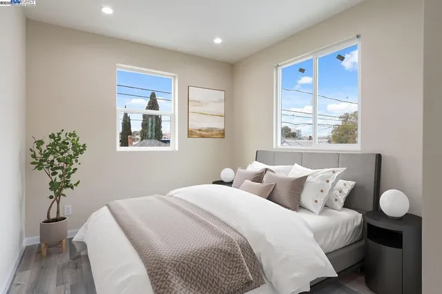 a bedroom with a bed and a potted plant